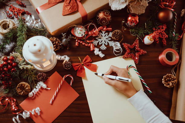 istock Young woman writing a Christmas card 1287328868