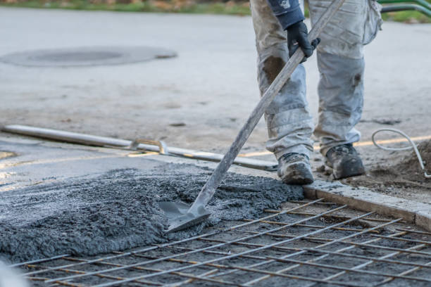 istock Close up on midsection of unknown worker spreading concrete cement mortar on the ground in day at construction site 1287334606