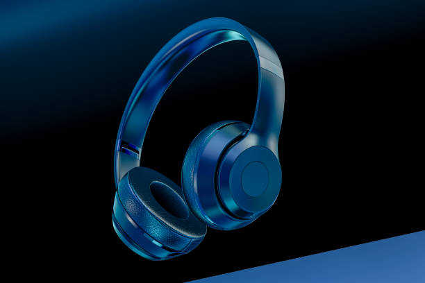 istock headphones on blue. Looking Down At Generic Music Headphones, Floating, Falling, Suspended, Isolated In A Blue and Black Studio Background 1287338732