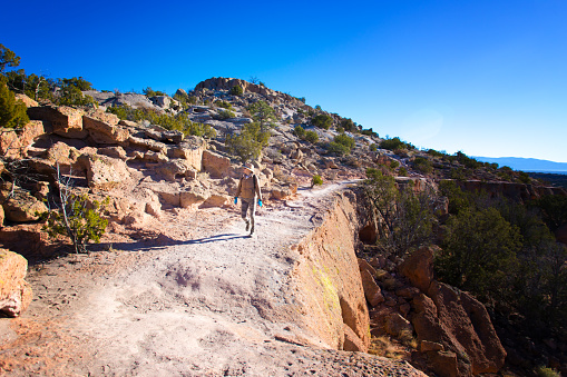 Hiker at Tsankawi Trail, Bandelier National Monument, near Los Alamos, NM.
