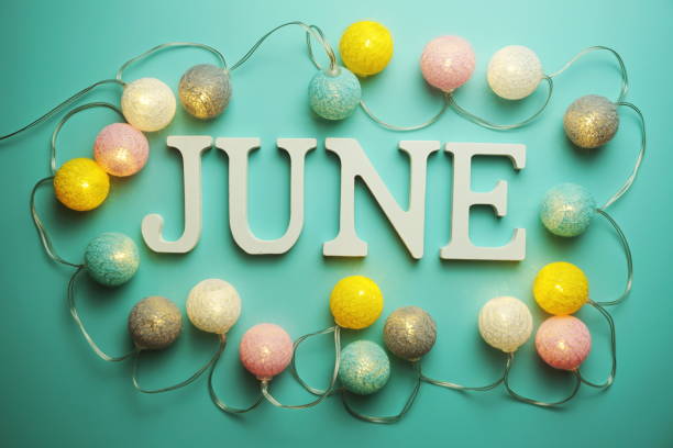 istock June alphabet letter with cotton ball LED decoration on blue background 1287343320