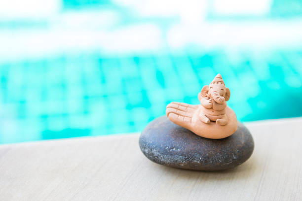 istock Miniature elephant sculpture on stone over blurred background, outdoor day light 1287346897