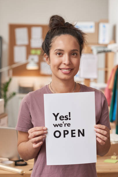 istock Woman opening her business 1287351182