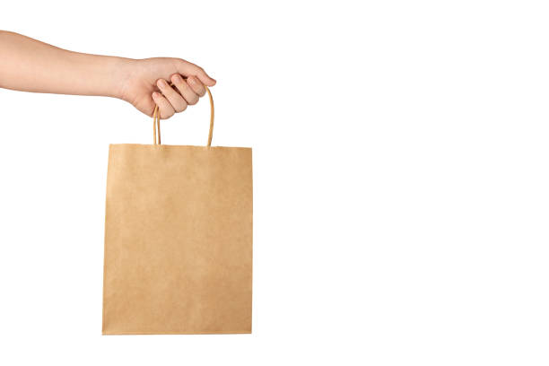 istock hand holds paper bag 1287351460