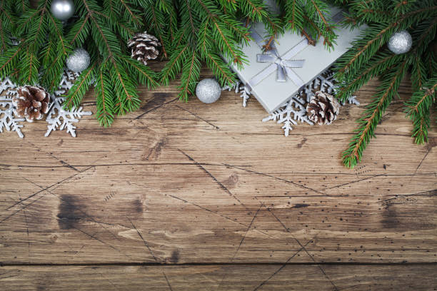 istock fir branches , gift , cones, snowflakes and balls on brown wooden background, top view flat lay copy space. Christmas and New Year background 1287353301