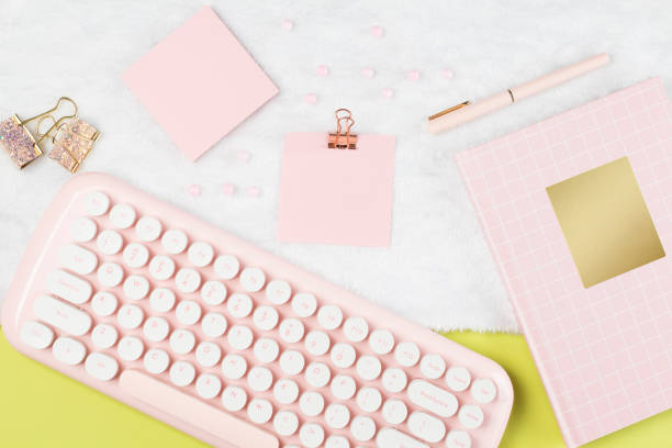 istock flat lay pink stationery on work desk in green pastel background 1287353843