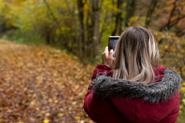 istock Woman making online content outdoor-autumn 1287354812