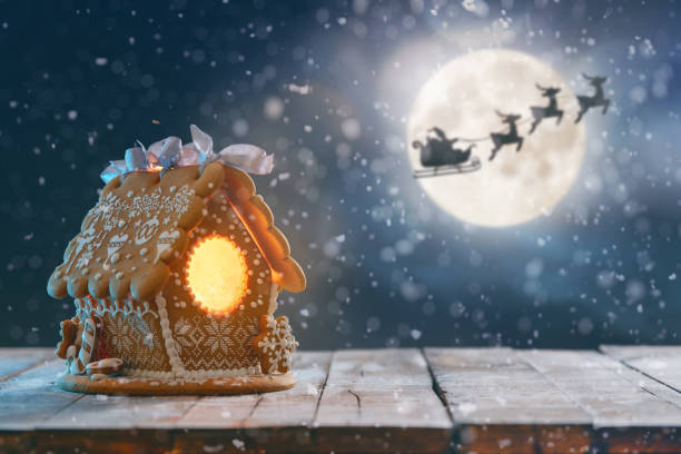 istock Gingerbread house on wooden table. 1287355557