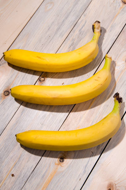 istock Bananas on a wooden table, close-up, place for text view from the side 1287355745