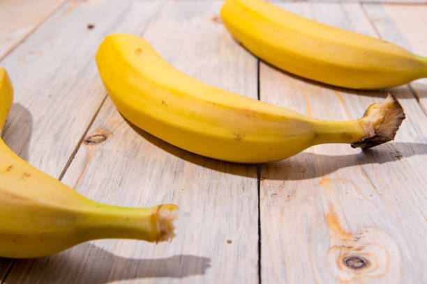 istock Bananas on a wooden table, close-up, place for text view from the side 1287355755