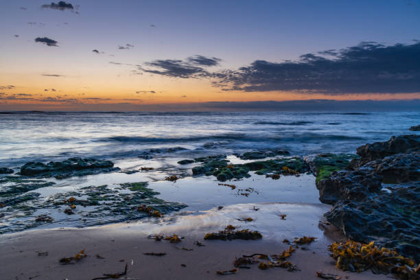 istock Rocky coastline sunrise seascape 1287356500