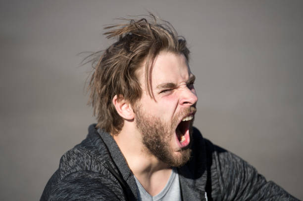 istock shouting or yawning handsome man or bearded guy 1287358428