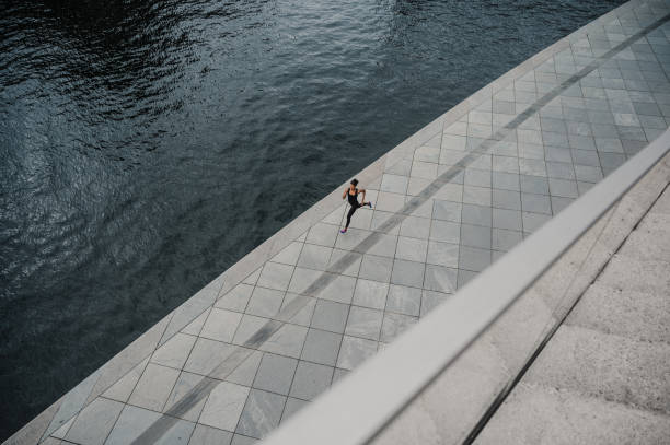 istock Woman running near the river 1287361488