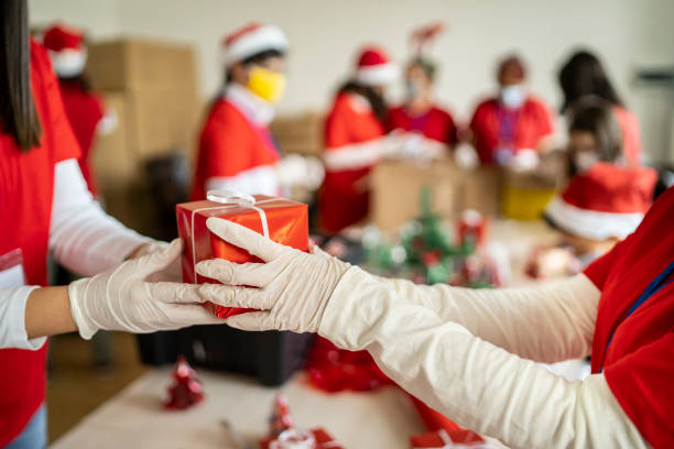 Gifts arrangement in time of pandemic Volunteers packing gifts for charity charitable foundation photos stock pictures, royalty-free photos & images