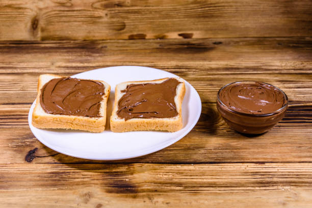 istock Two sandwiches with chocolate spread on a white plate 1287363600