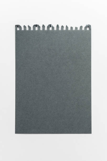 istock torn sheet of notebook paper gray on a white background. grey mocap paper 1287363618