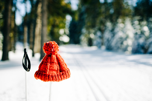 Close-up of Red Wool cap on ski pole in Bohemia Winter landscape