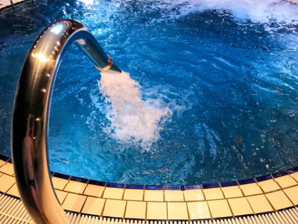 istock Round Pool in the spa. Charcot shower in the pool 1287365183