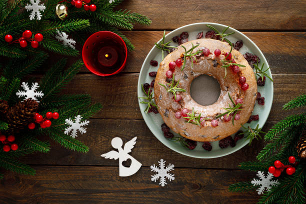 istock Christmas cranberry fruit cake with decorations on wooden background 1287366821