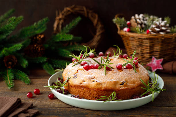 istock Christmas cranberry fruit cake with decorations on wooden background 1287367960