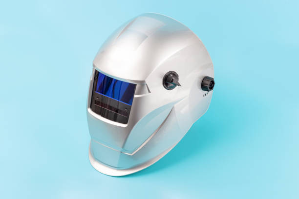 istock Welding mask isolated on blue background close-up. 1287371980