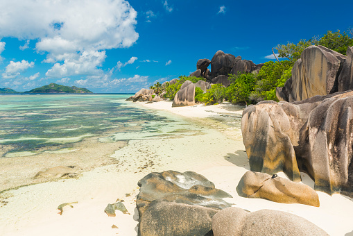 Famous view at beautifully shaped granite boulders and a perfect white sand at the famous Anse Source d'Argent beach, La Digue island, Seychelles