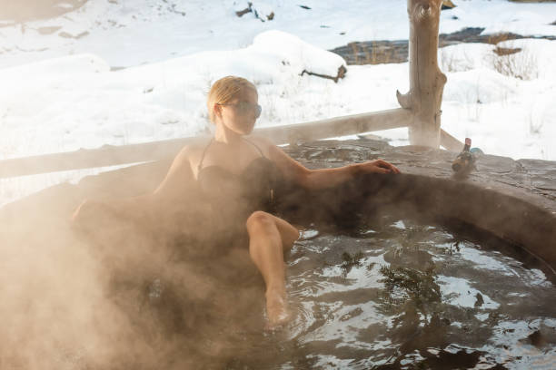 istock Young lady relaxing outside in thermal bath in winter 1287373276