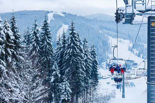 Ski resort modern ski lift and  Snowmaking  with snow gun.  Ski slope artificial snowing. Ski resort  with snow cannon - snow making machine. Beautiful winter nature. Fresh snow on the top of  mountains.  High mountain landscape  Ski area Passo Tonale