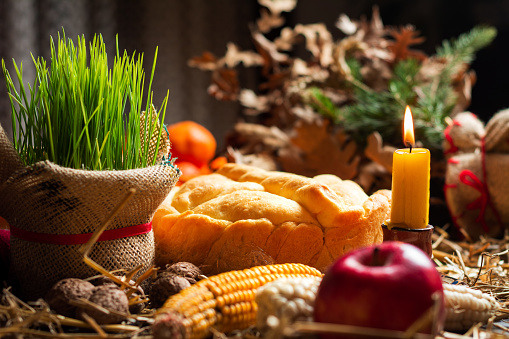 Homemade religiously decorated bread with Orthodox Christmas eve arrangements and offerings table top view. Serbian Christmas Eve celebration and religion abstract