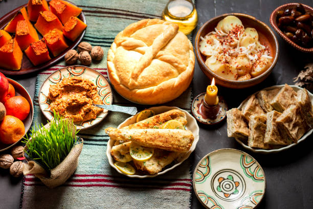 Homemade bread and Orthodox Christmas eve fasting food dinner on the table Homemade religiously decorated bread and Orthodox Christmas eve fasting dinner including fish and vegetables on the table. Serbian Christmas Eve celebration and religion abstract slavic culture photos stock pictures, royalty-free photos & images