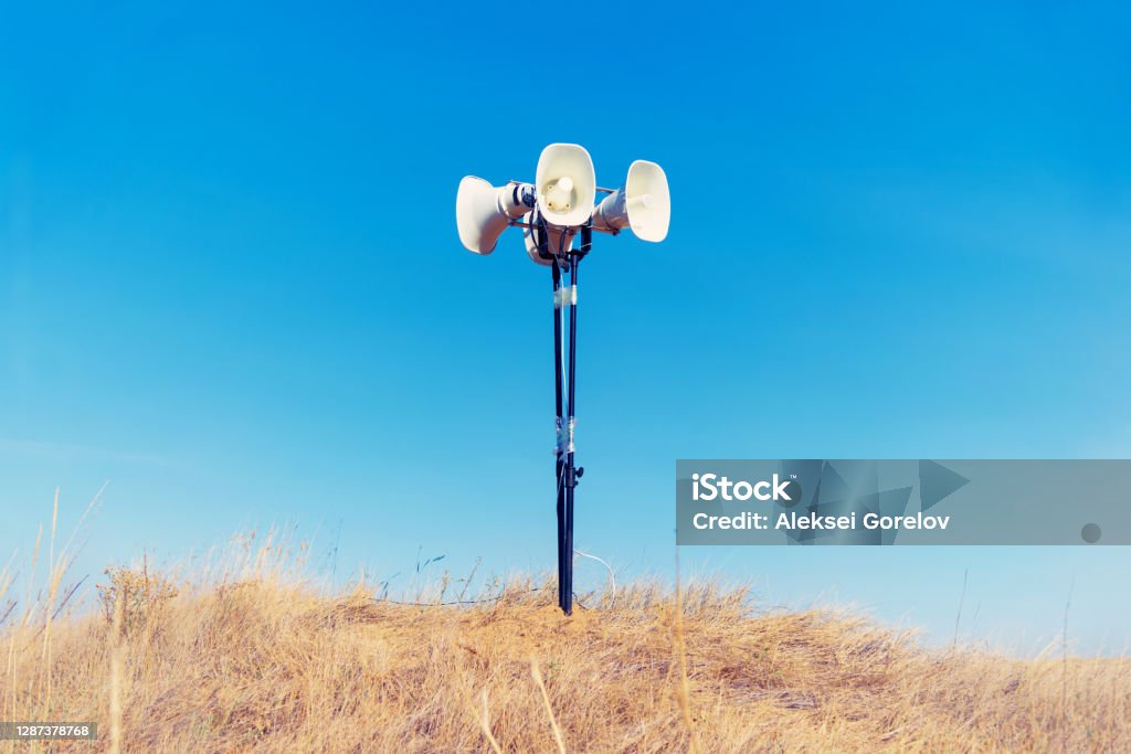 in the field on the ground is a loudspeaker Agricultural Field Stock Photo