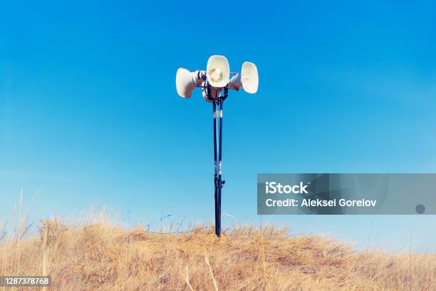 In The Field On The Ground Is A Loudspeaker Stock Photo - Download Image Now - Agricultural Field, Megaphone, Alertness