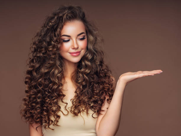 istock Beautiful woman presenting your product 1287379340