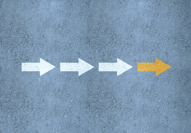 istock Team, follow your leader, road marking arrows (yellow and white) with structure 1287379409