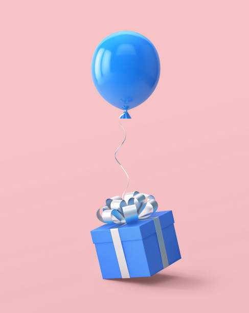 istock Blue gift box with silver ribbon and balloon isolated on pink 1287379508
