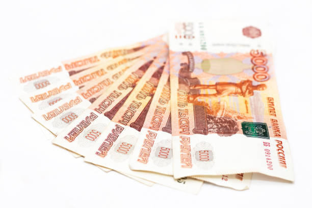 istock Scattered Russian 5000 rubles banknotes closeup isolated on the white background 1287379716