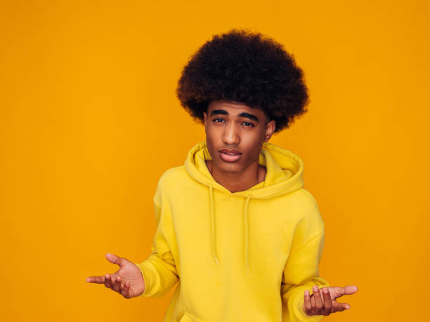 istock Confused young guy wearing yellow hoodie 1287379794