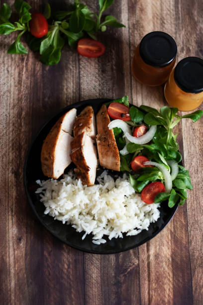 istock Ready chicken breast with rice and salad. 1287380058