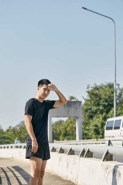istock Young Asian people jogging in the city 1287381849