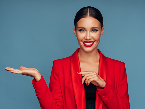 Beautiful emotional woman presenting your product