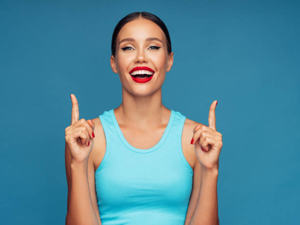 istock Beautiful woman pointing up 1287382664