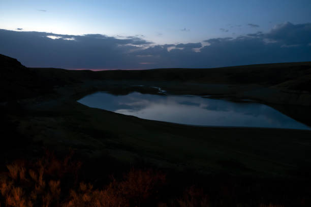istock Dusk lake sunset in steppe on light background. Natural light. Sunset river water reflection. Kurty lake. Kurtinskoye lake. 1287382904