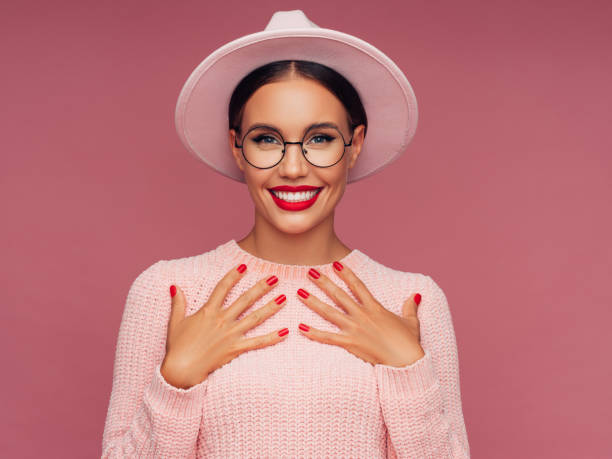 Beautiful woman wearing pink hat Beautiful woman wearing pink hat luxury eyewear stock pictures, royalty-free photos & images