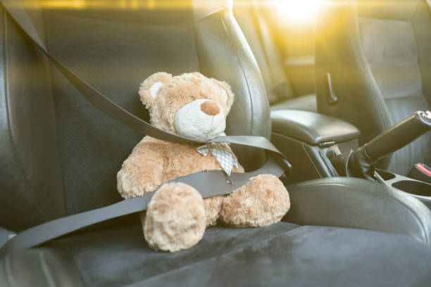 istock small teddy bear protected with safety belt in car, vehicle accident security 1287383330
