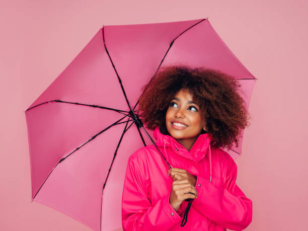 Afro girl with pink umbrella