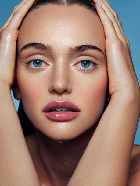 istock Beautiful woman washing her face 1287384688