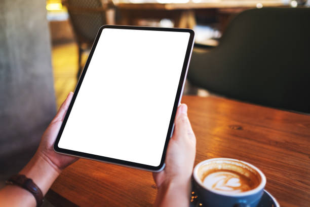 istock a woman holding digital tablet with blank white desktop screen 1287385465