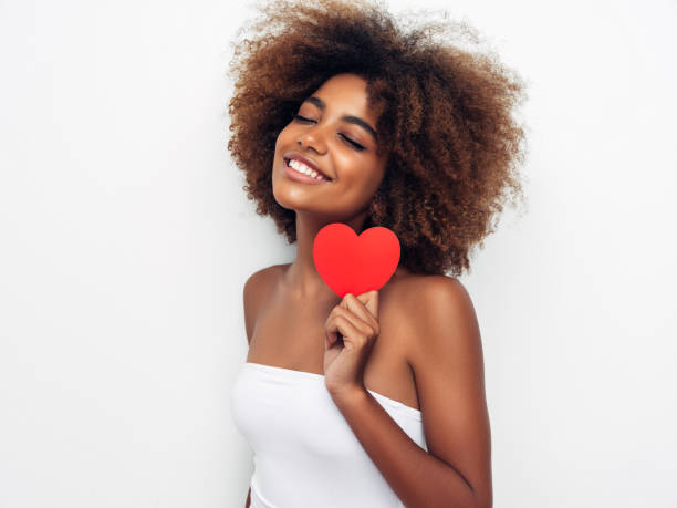 istock Beautiful afro woman holding artificial heart 1287385561