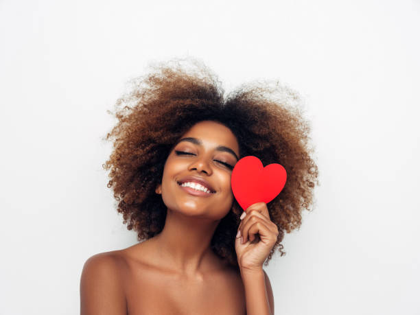 istock Beautiful afro woman holding artificial heart 1287385754