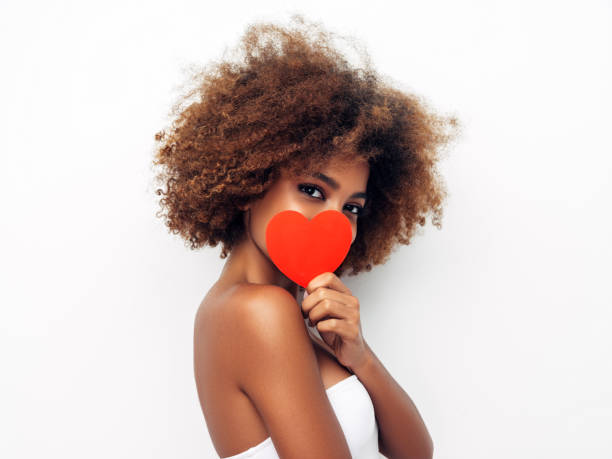 istock Beautiful afro woman holding artificial heart 1287385837